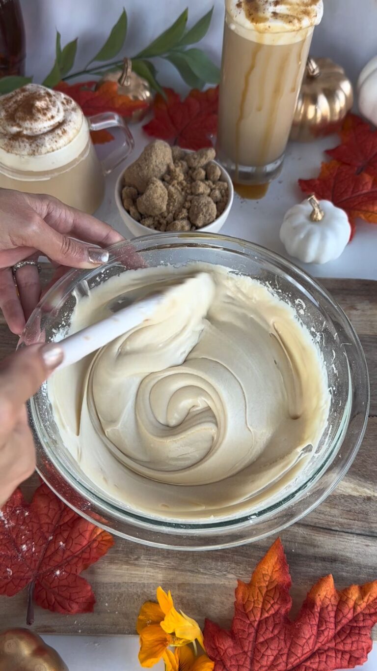 coffee frosting being mixed with a spatula in a mixing bowl